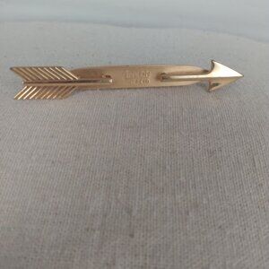 Anson: Gold tone tie clip.
